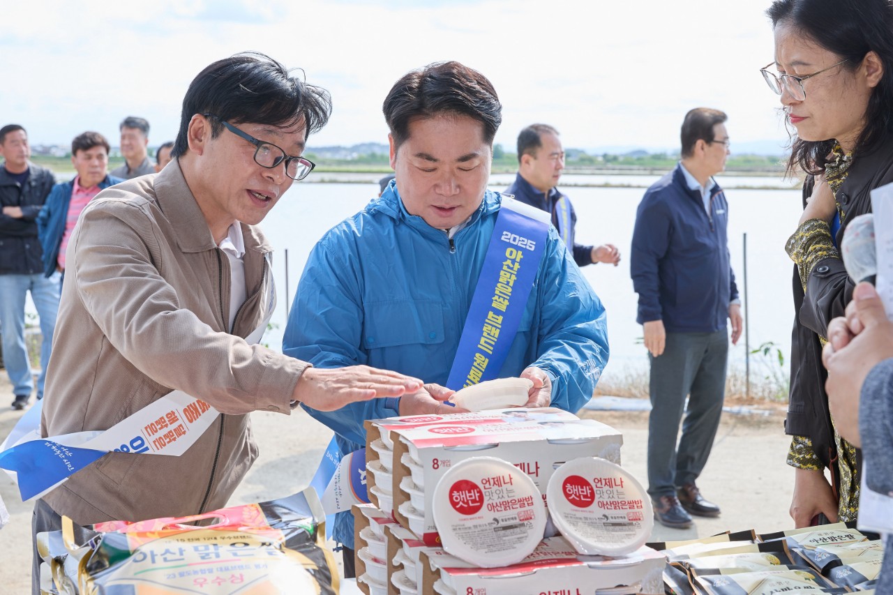 김정규 농업기술센터 소장이 오세현 아산시장에게 아산맑은쌀을 원료곡으로 만들어진 CJ제일제당(주)의 햇반을 설명하고 있다. 
