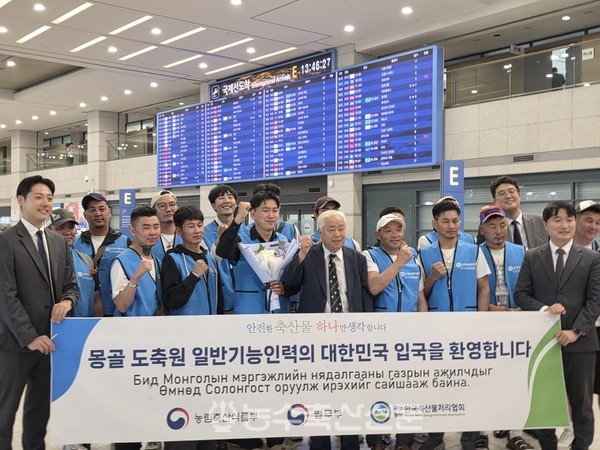 김명규 한국축산물처리협회장(가운데)과 직원들이 14일 인천국제공항 제1여객터미널에서 몽골 출신의 도축 전문인력 15명과 단체 기념촬영을 하고 있다.